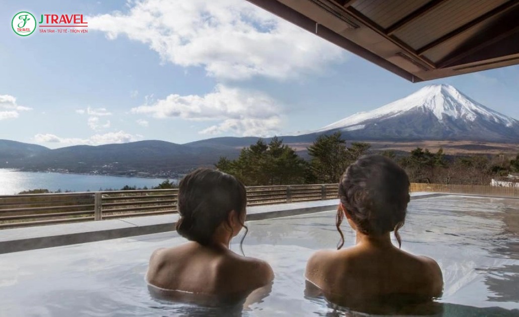 Du khách thư giãn tại suối nước nóng onsen với view núi Phú Sĩ
